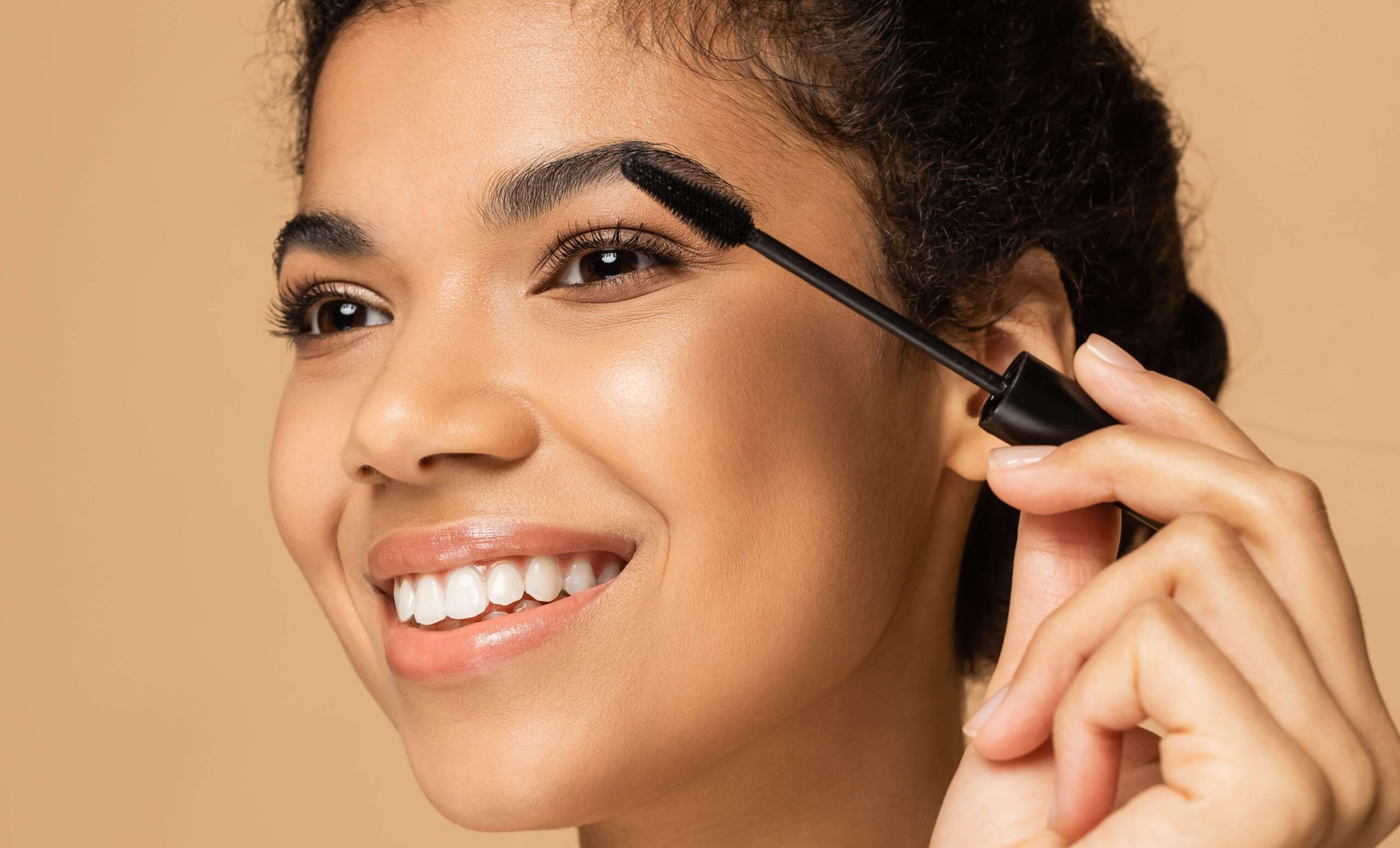 Girl brushing her eyelashes